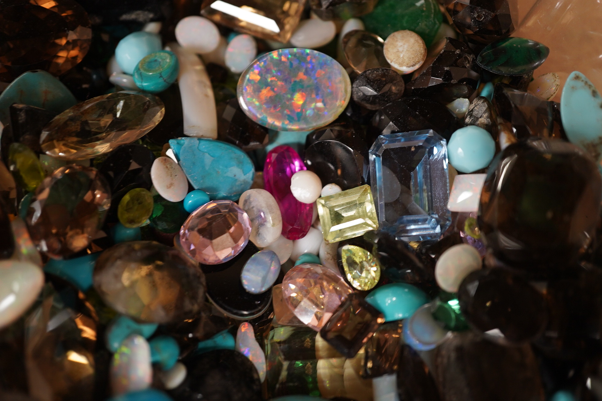 A large quantity of assorted unmounted cut and cabochon gemstones etc, including opal, quartz and turquoise. Condition - poor to fair to good